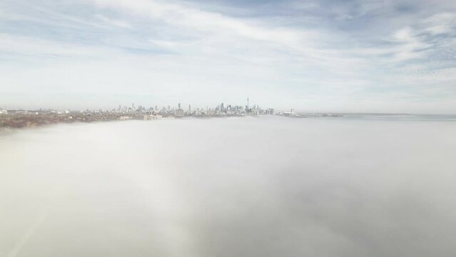 The best shot of Toronto, Canada as viewed from a helicopter flying toward to the city through the clouds