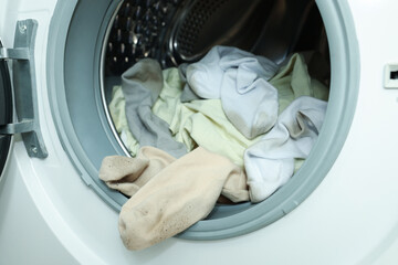 Many dirty socks in washing machine, closeup