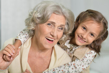 Grandma carrying her granddaughter at her back