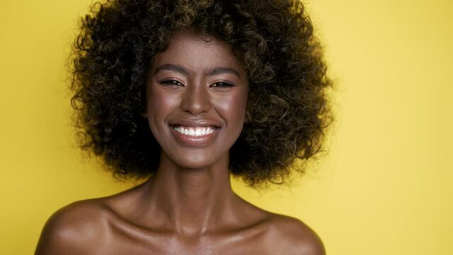 Smiling ethnic woman with curly hair