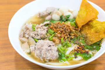 Noodles with minced pork in water, delicious, cooked with fried garlic, minced pork, fish balls, bean sprouts, topping seasoned with chili powder, sugar, fish sauce, street food, Thai food