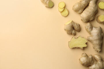 Fresh ginger on beige background, flat lay. Space for text