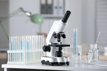 Modern medical microscope on white table in laboratory