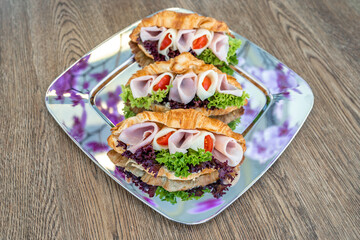 Croissant filled with ham, cheese and vegetables