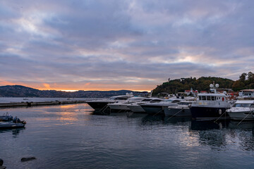 Sailboats at Tarabya yacht marina in Istanbul. Reflection of yachts and hotel. Blue sky and natural white clouds.