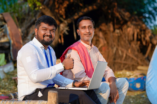 Young Indian Banker Or Agronomist Showing Thumps Up With Farmer At Home