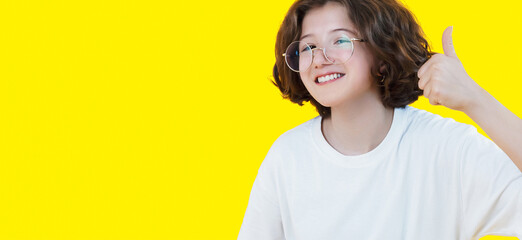 funny girl in glasses showing thumb up everything is super cool isolated on colored background, copy space