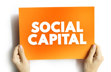 Social Capital - networks of relationships among people who live and work in a particular society, enabling that society to function effectively, text concept on card