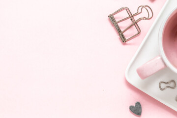 A feminine workspace, keyboard of a computer on pink background with copy space