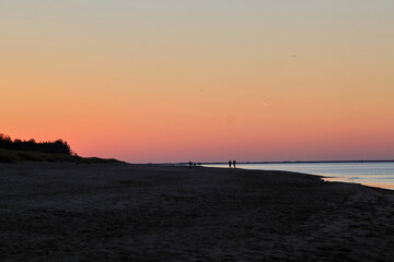 Calm pastel sunsetting sky on the sea beach. Selective focus