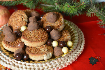 Obraz na płótnie Canvas Christmas cookies on a plate on a decorated table. Dessert of cookies plate perfect for celebrating Christmas.