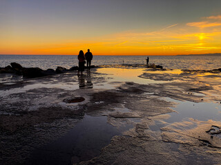 Fisherman on the beach of Camogli during a beautiful sunset.