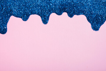 Shiny border made of glitter gel on a colored background. Christmas background with copy space