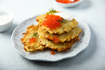 Homemade latkes with red caviar