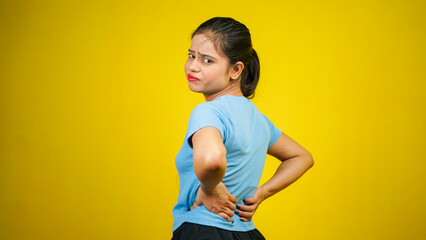 Caucasian young woman suffering from lower back pain or backache, Indian girl having back ache,...