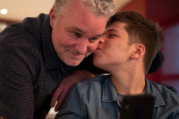 Son kissing father in cheek