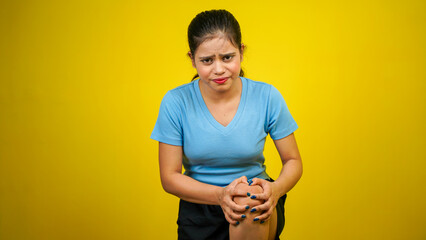 Woman suffering joint pain, Arthritis and tendon problems, women touching knee, isolated yellow...