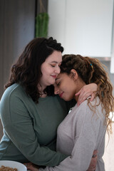 Fototapeta premium Two women embracing at home