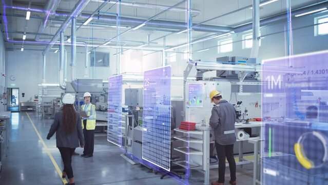 Factory Digitalization: Two Industrial Engineers Use Laptop Computer, Big Data Statistics Visualization, Optimization of High-Tech Electronics Facility. Industry 4.0 Machinery Manufacturing Products