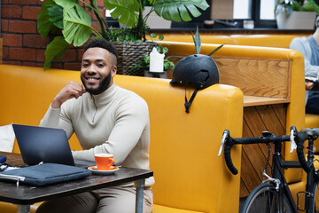 Man sitting in office lounge using laptop