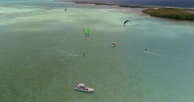Drone shot turn around boat stand waiting friends practing kiteboard, Salinas los Roques