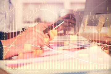 Fototapeta na wymiar Double exposure of man's hands holding and using a phone and financial chart drawing. Market analysis concept.