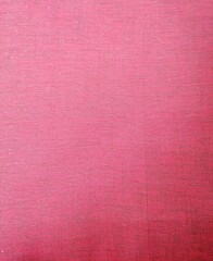 Fondo con detalle y textura de superficie textil con tonos rosados y suave degradado de luz