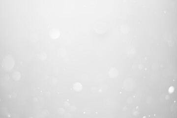 White glitter vintage lights background.  White bokeh shiny on dark background.