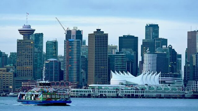 Seabus driving in front of Downtown Vancouver 4K 2021, beautiful view of Canada Place and the whole Waterfront, scenic high rise perspective in overcast light
