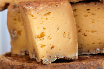 Photo of a handcrafted hard cheese on a village fair. Selective focus
