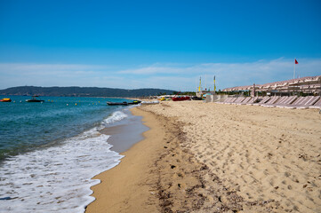 Crystal clear blue water of legendary Pampelonne beach near Saint-Tropez, summer vacation on white sandy beaches of French Riviera, France