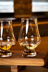 Flight of single malt scotch whisky in glasses served in whiskey bar in Edinburgh, UK