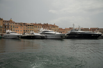 Fototapeta premium Colorful houses and yachts in Port of Saint Tropez, village on Mediterranean sea with yacht harbour, Provence, France