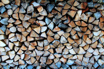 A lot of stacked woodpile, firewood. Selective focus. Background, texture
