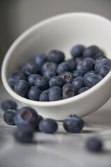 A group of fresh blueberries on a white and black marble table. 