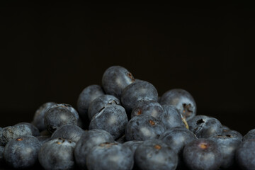 A group of fresh blueberries on a black background