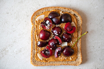 Open sandwiches with cherries. Made from wholegrain bread, cherries and peanut butter