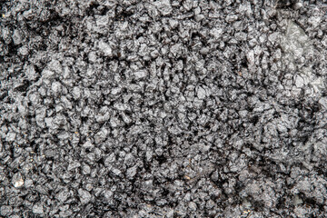 Coarse and fine gravel filled with black resin. Abstract graphic background.