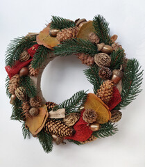 Fototapeta na wymiar Christmas Wreath of pine branches, cones, leaves, beads and snowflakes. Holiday Decoration Gift For family and friends. New Year's home wall decor different angles handmade top view, side view