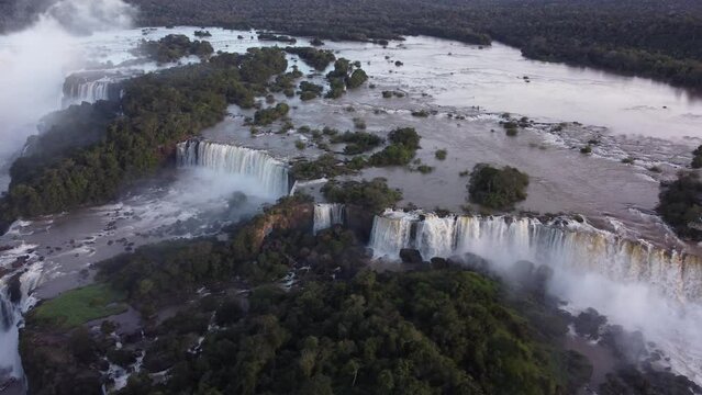 aerial view of the Iguazu Falls on the border of Argentina and Brazil at sunset, flying towards the main waterfalls Garganta del Diablo