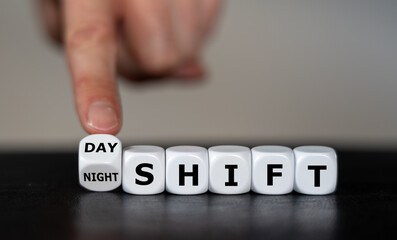 Hand turns dice and changes the  expression 'day shift' to 'night shift'.