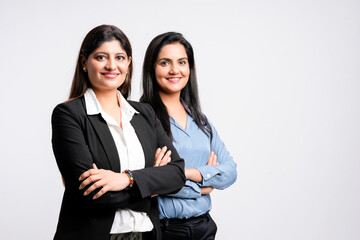 Young confident indian businesswoman standing on white background.