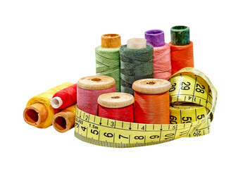 Multicolored thread spools and measurement tape isolated on transparent.