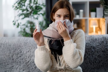 Sick woman holding nasal spray