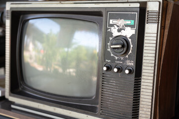 A vintage style television with built-in manual adjusting switch panel.