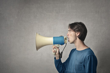 young man yells into a megaphone