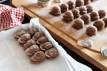Putting nut shaped Christmas cookies into a gift box