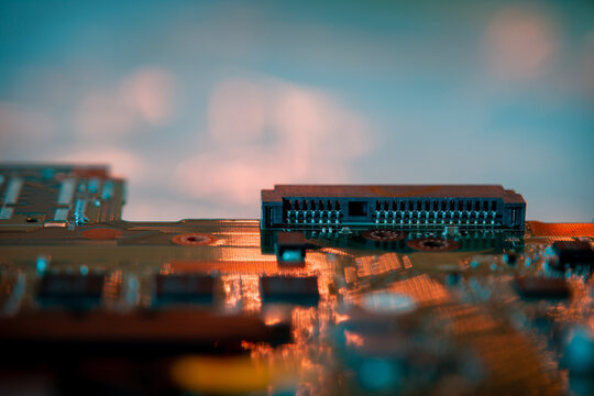 Fixture on circuit board with teal and red highlights.