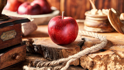 Red apple on an old wooden table top.