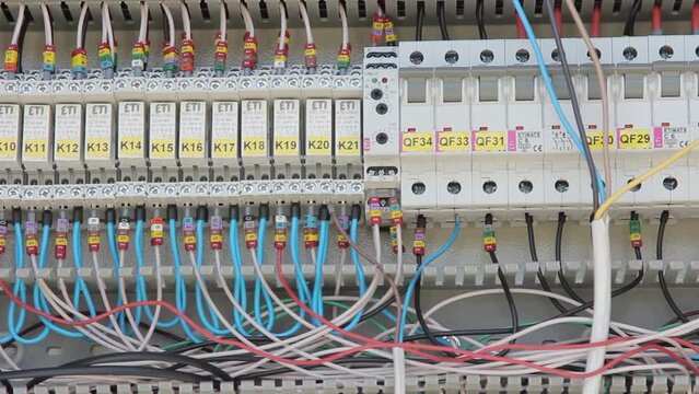 Cabinet with wires and cables connecting circuit breakers. Electrical enclosure with high-voltage equipment protecting contents from environment closeup